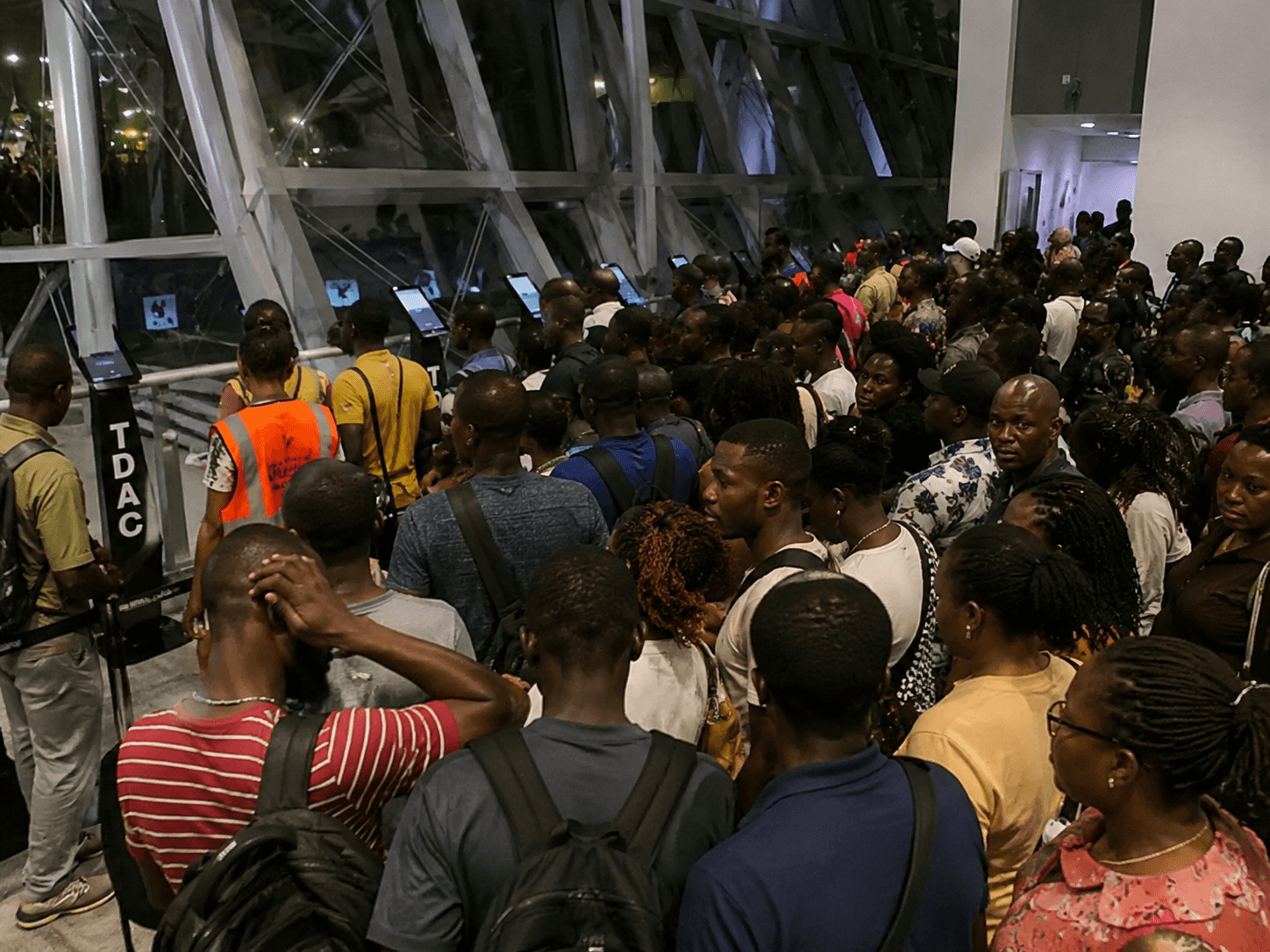 Crowded airport TDAC queue at night